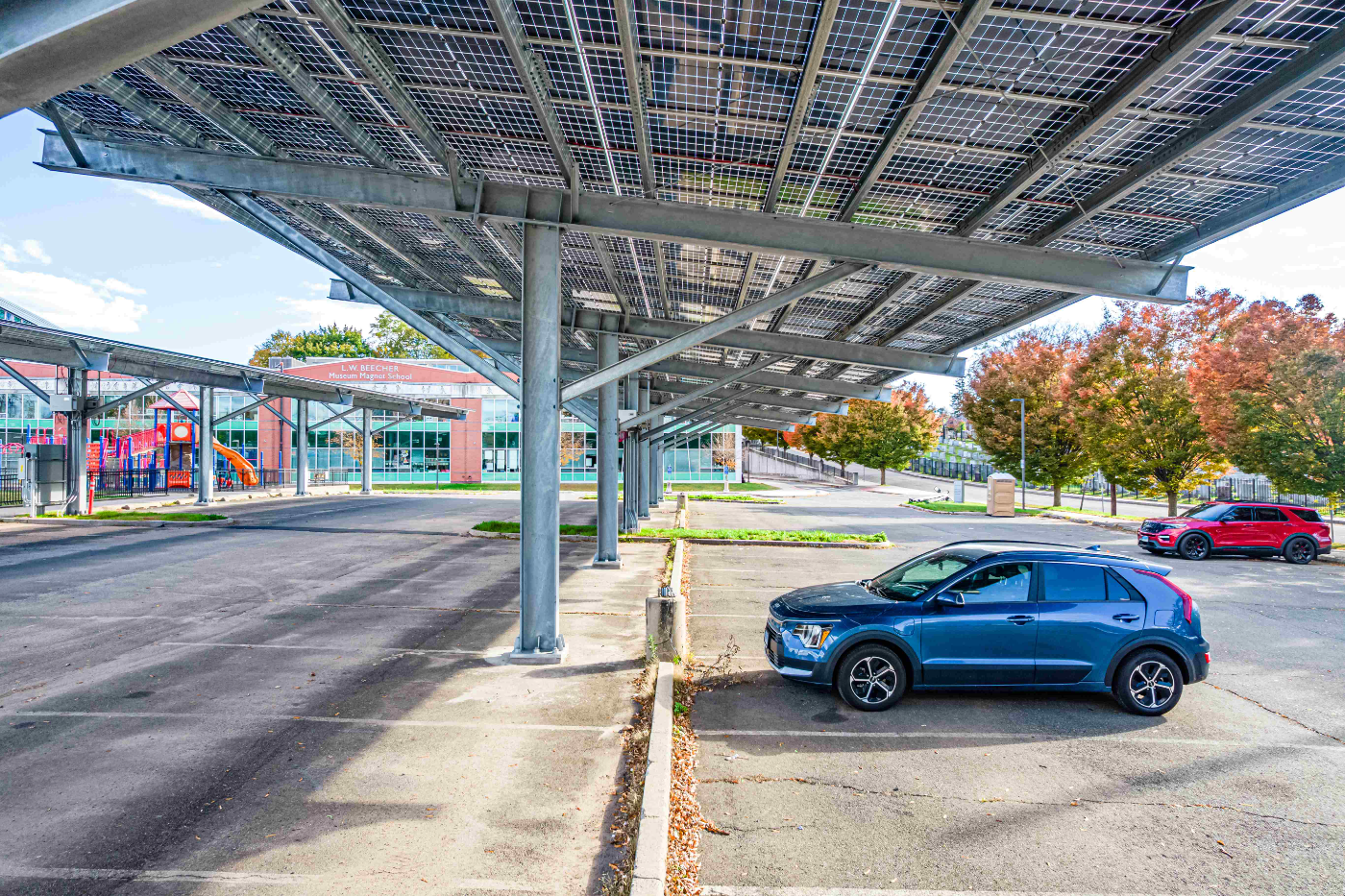 Solar carport shading a paved lot