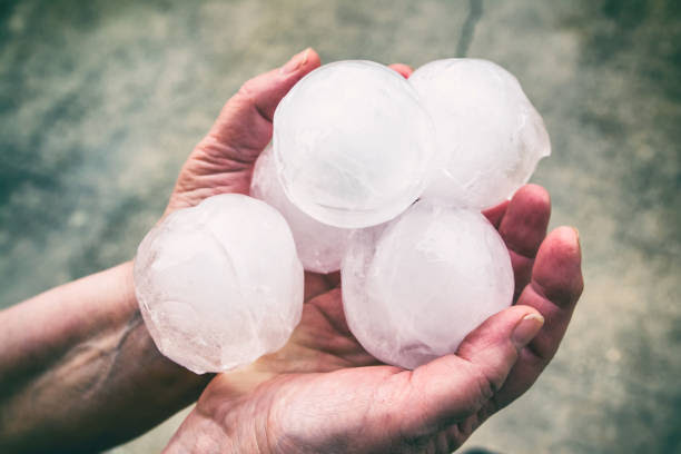 Golf-ball-sized hailstones held in two hands